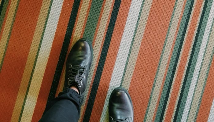 Person Wearing Pair of Black Leather Lace-up Dress Shoes